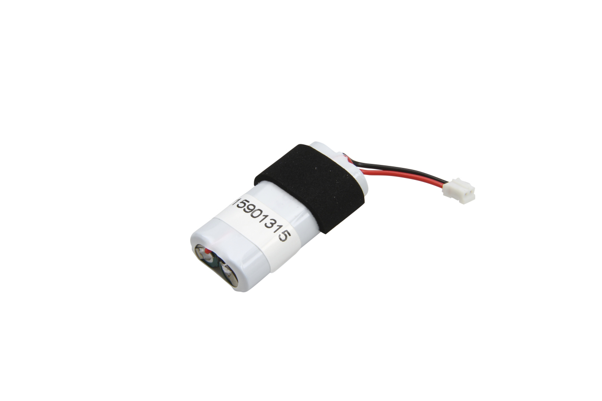 Two cylindrical, white batteries are held together with black tape. A white label marked ‘15901315’ is wrapped around them. At one end, a red and a black cable lead to a small white 2-pin plug.