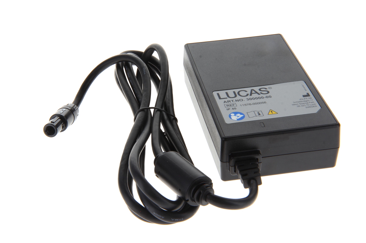 Schwarzes, rechteckiges Physio Control Netzgerät für Lucas 3, Typ 11576-000056, mit fest verbundenem schwarzem Kabel und speziellem Rundstecker. Auf dem Etikett: Marke LUCAS, Artikelnummer 300000-00, Schutzart IP40.
